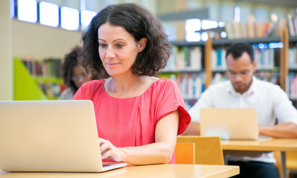 happy-female-adult-student-passing-online-test